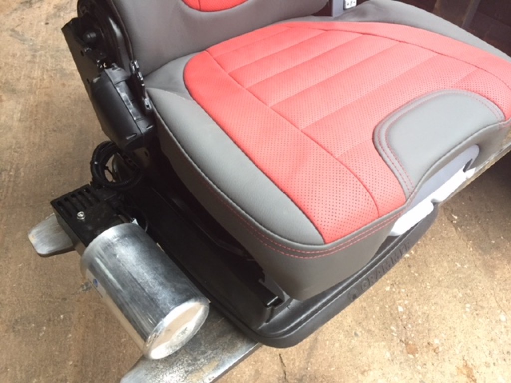 new Case Evolution tractor seat, air sprung, red/grey leather, telescopic headrest, heating switches, complete with left hand armrest, manufactured by Grammer