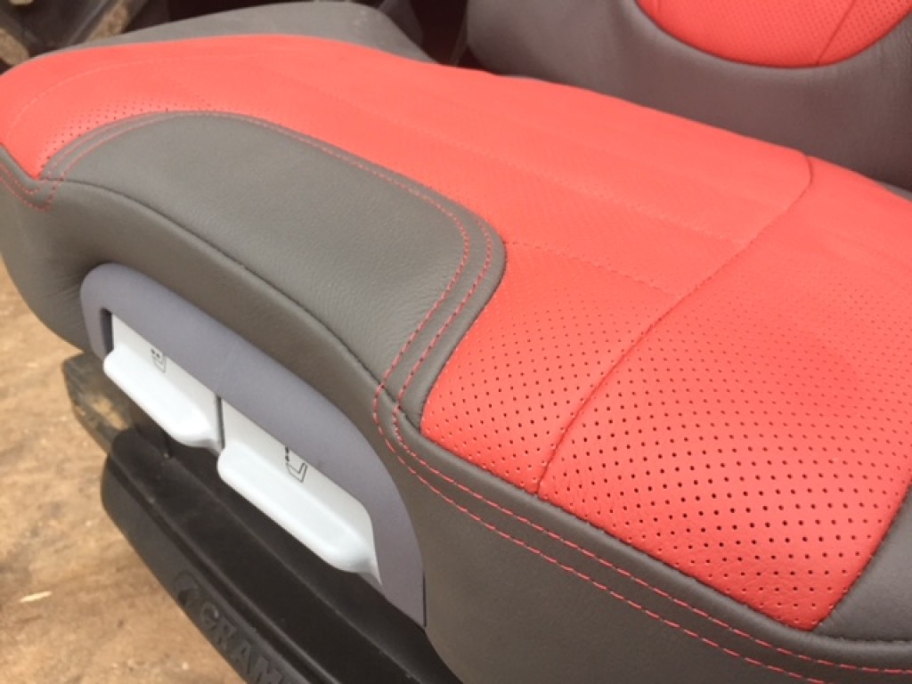 new Case Evolution tractor seat, air sprung, red/grey leather, telescopic headrest, heating switches, complete with left hand armrest, manufactured by Grammer